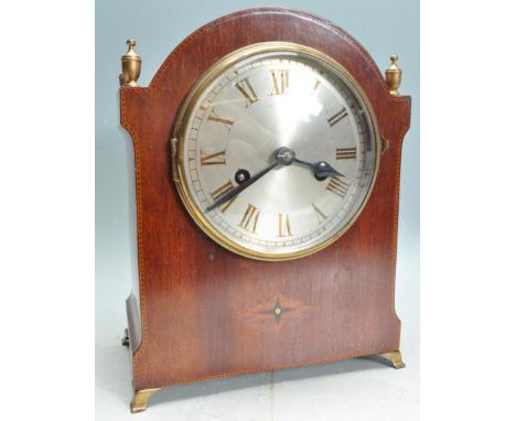 An early 20th century Edwardian oak cased dome topped 8 day mantle clock having brass finial embellishments with a silvered c