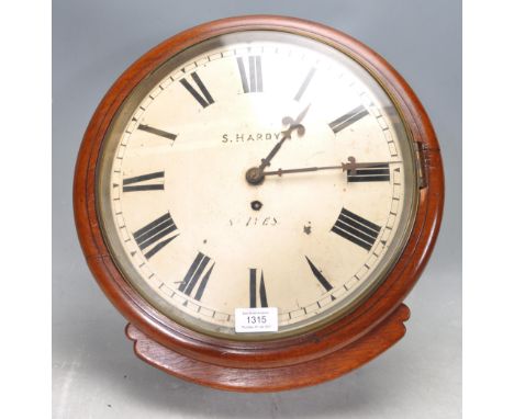 An antique late 19th century Victorian mahogany station wall hanging / postman's / railway clock having a circular mahogany s