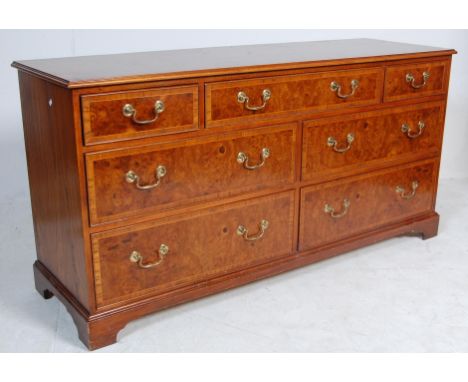 A large contemporary Georgian antique style double chest of drawers / sideboard credenza having a flared top with panelled wa