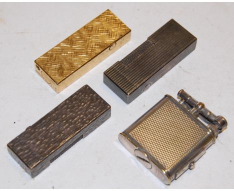 Four various Dunhill pocket cigarette lighters to include engine turned example   Condition Report / Extra Information  Dunhi