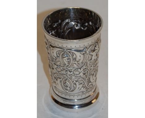 A late Victorian silver beaker of circular tapering form with all over repoussè decoration, the cartouche inscribed Eastbourn