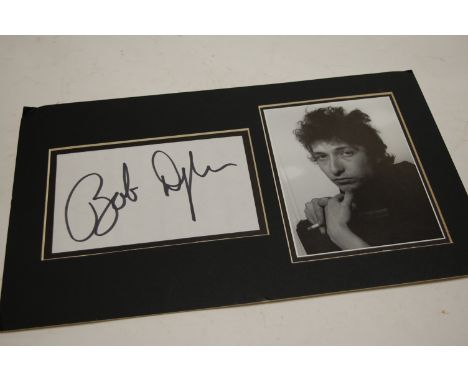 A black and white photograph of Bob Dylan with separate signature on paper (mounted)