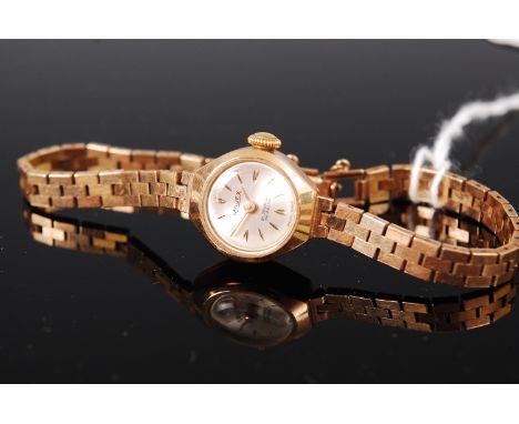 A ladies Majex 9ct gold wristwatch, having signed silvered dial, manual wind movement and gold bracelet, gross weight 14.2g