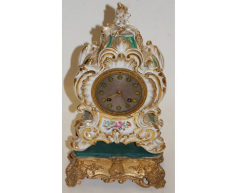 A late 19th century French porcelain cased mantel clock having a silvered dial with Roman numerals and eight day movement str