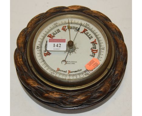 An Edwardian aneroid barometer, the dial signed SS Burlingham of Kings Lynn within carved rope twist surround