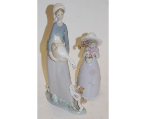 A Lladro figure of a girl in standing pose, holding a goose with a dog at her feet, printed mark verso; together with one oth