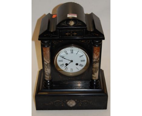 A late Victorian black slate cased mantel clock of architectural form having enamelled dial with Roman numerals and eight day