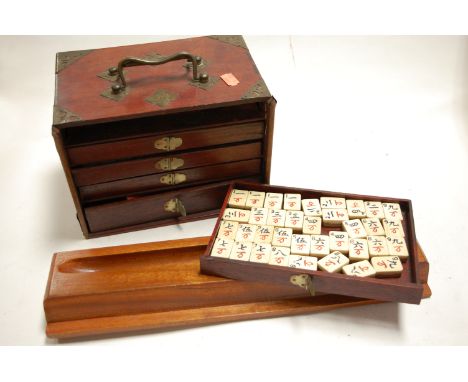 A mid 20th century Mah Jong set in fitted brass mounted wooden box together with various wooden Mah Jong tile racks   Conditi