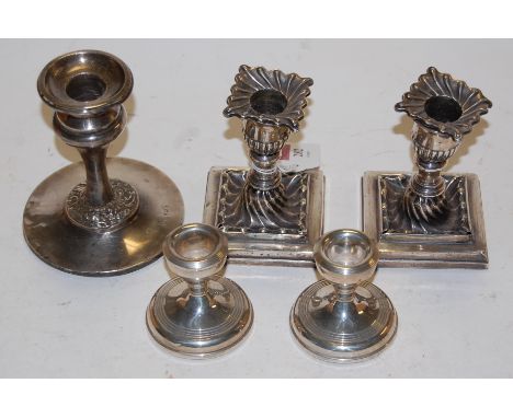 A pair of late Victorian silver dwarf candlesticks with detachable sconces (a/f); together with one other pair of silver dwar