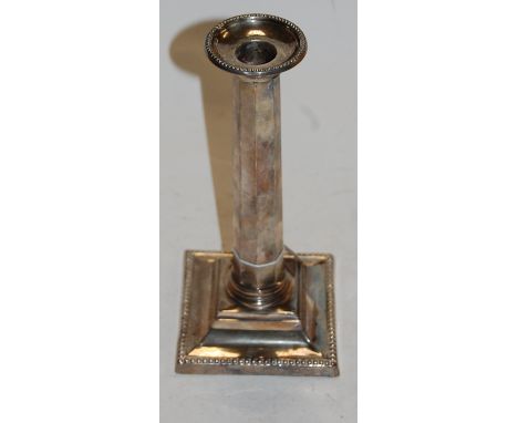 An early 20th century silver octagonal candlestick on square loaded base, h.24cm