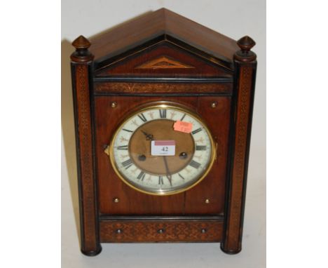 A late 19th century Continental walnut cased mantel clock, having enamelled chapter ring with Roman numerals, and eight day m