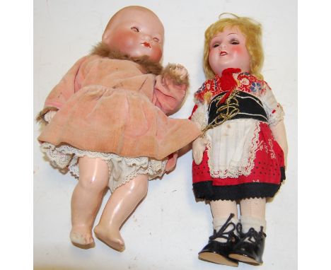 An Armand Marseilles of Germany bisque headed baby doll, having flirty eyes, numbered 571/2.K; together with an Armand Marsei
