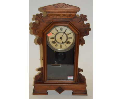 A late 19th century walnut cased mantel clock, by the Ansonia Clock Company of New York, having a paper dial with Roman numer