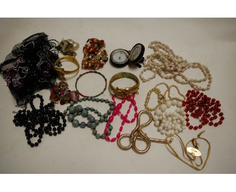 A large collection of assorted costume jewellery to include dolphin bangle, abalone shell earrings, beaded necklaces etc