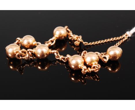 A yellow metal ball link bracelet with safety chain, apparently unmarked, 20.7g