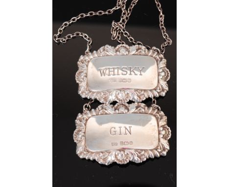 A pair of modern silver and embossed decanter collars for whisky and gin 