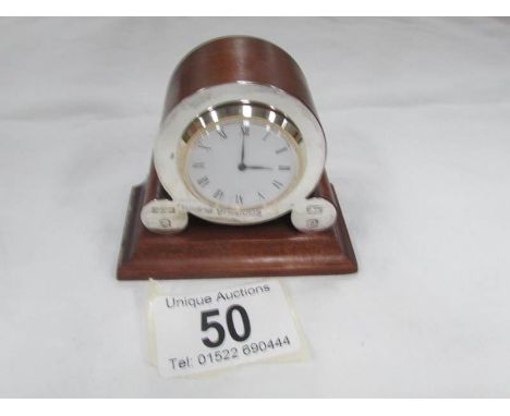 A miniature mantle clock with silver mounts hall marked London.