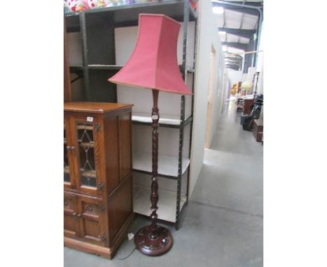 An oak standard lamp with shade.