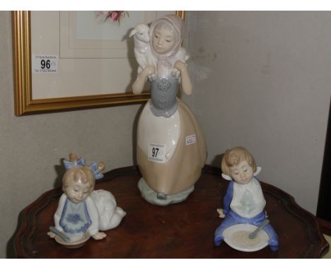 A large NAO figure of girl with lamb and a pair of NAO breakfast time figures,