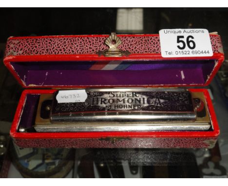 A boxed vintage Hohner Super Chromonica Chromatic harmonica.