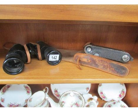 A pair of binoculars and a vintage camera.