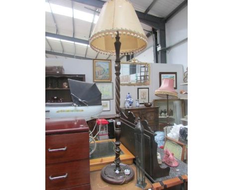 An oak standard lamp with shade.