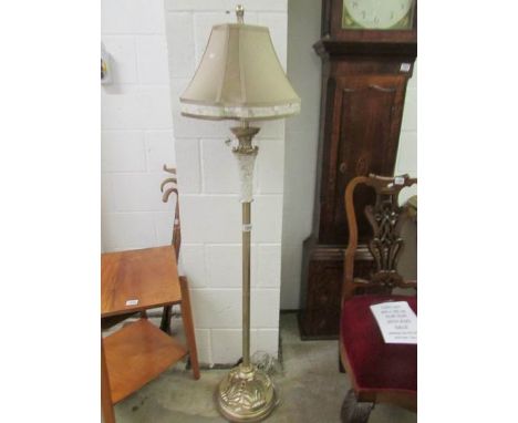 A modern standard lamp with shade.