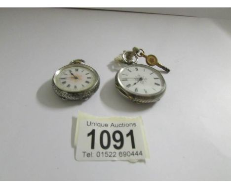 Two vintage chased silver fob watches with enamel faces, early 20th century.