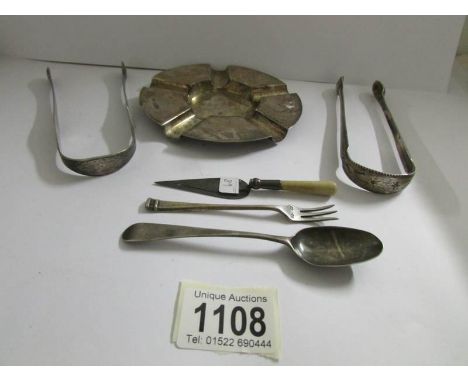 A silver ashtray, 2 silver sugar tongs, a spoon, small eel fork and Mason's trowel page turner, approximately 174 grams.