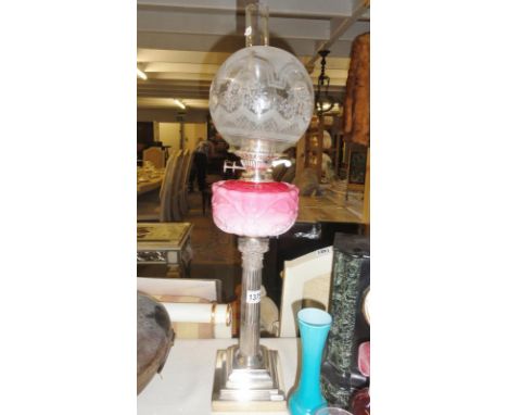 A Victorian silver plated peg oil lamp with pink glass font.