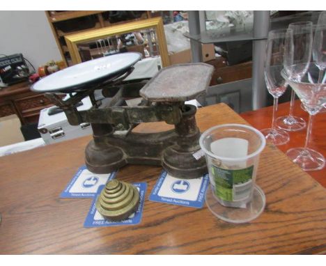 A set of kitchen scales with weights.
