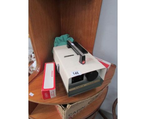 A vintage slide projector and slides.