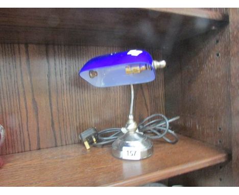 A small bankers lamp with blue glass shade.