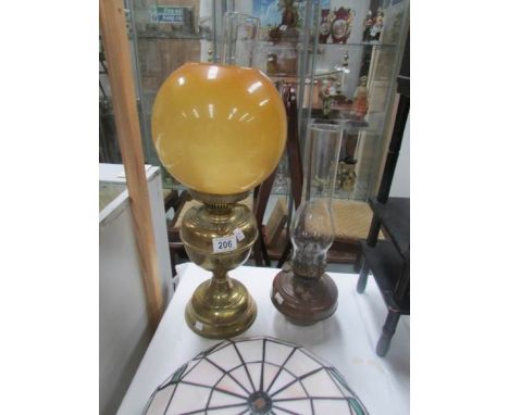 A brass based oil lamp with glass shade and a copper oil lamp font with chimney.