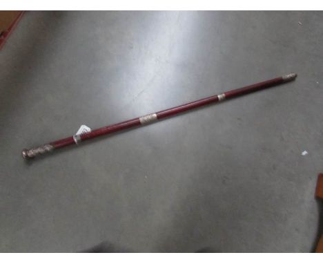 A leather bound walking stick with silver mount.