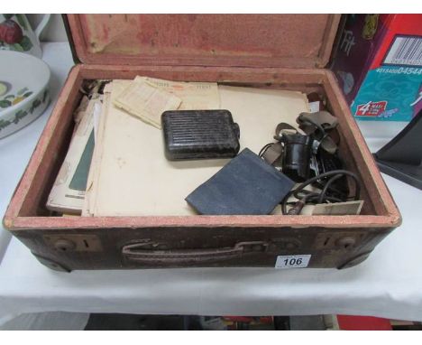 A case of assorted WW2 memorabilia including photographs, commemoration service booklets, electric light, item with Nazi eagl