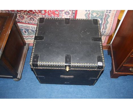A small leather and studded trunk