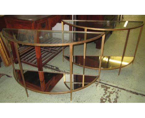 DEMI-LUNE CONSOLE TABLES, a pair, gilt metal each with glass top and mirrored undertier, 76cm H x 127cm W x 43cm D. (2)