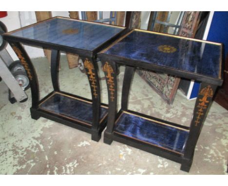 LAMP TABLES, a pair, Regency style ebonised and gilt decorated each with glazed tops and undertier and curving supports, 61cm