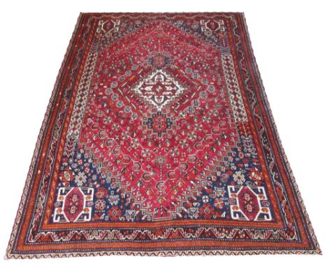 UNUSUAL QUASHQAI CARPET, 293cm x 200cm, central ivory medallion on a terracotta field of botehs and stylised flowers inside m