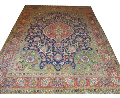 FINE ANTIQUE PERSIAN TABRIZ CARPET, 440cm x 340cm, terracotta pole medallion on a midnight blue field of palmettes and scroll