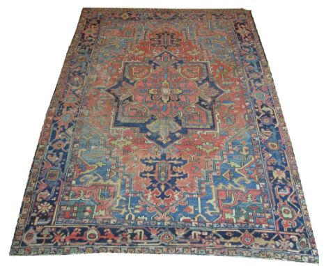 ANTIQUE PERSIAN HERIZ CARPET, 308cm x 210cm, circa 1890, star medallion on a terracotta field inside a corresponding midnight