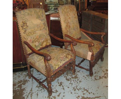 FAUTEUILS, two similar, Louis XIV style, walnut, with foliate carved arm terminals, landscape tapestry upholstery (with fault