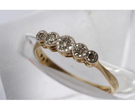 A gold ring inset with five small diamonds