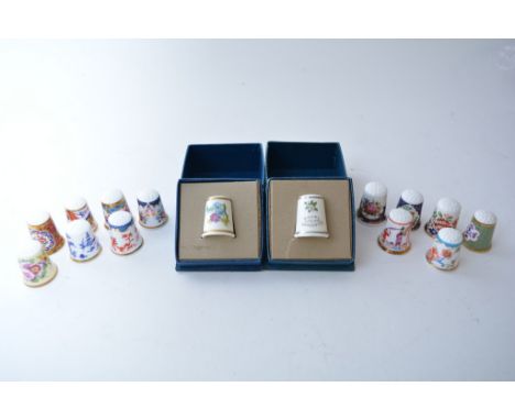 A collection of thirteen Royal Worcester "Historic Series" thimbles and two boxed Royal Worcester thimbles