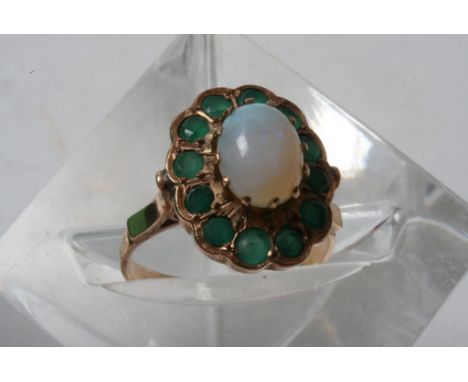 A 14ct gold ring with unusual setting of single opal in emerald mount