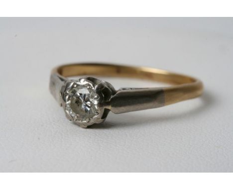 A diamond solitaire ring set in 18ct gold and platinum