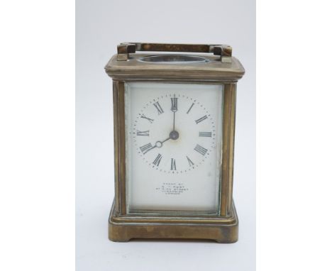 A French brass cased carriage clock with leather travelling case and key.