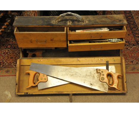 A wooden tool chest containing various saws, planes etc.