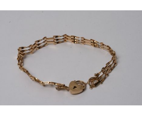 A three bar 9ct gold gate bracelet with padlock clasp